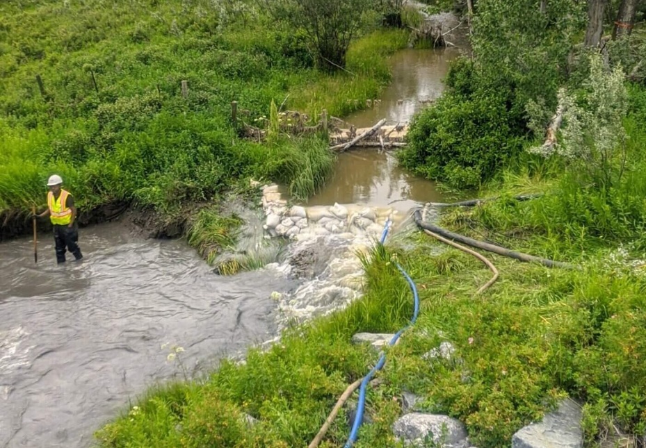 Crew working in a creek with water management in place